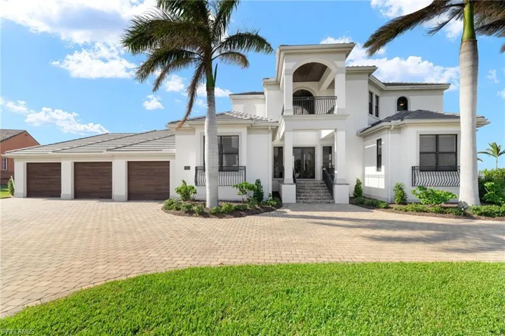 Mediterranean / spanish house with a balcony and a garage