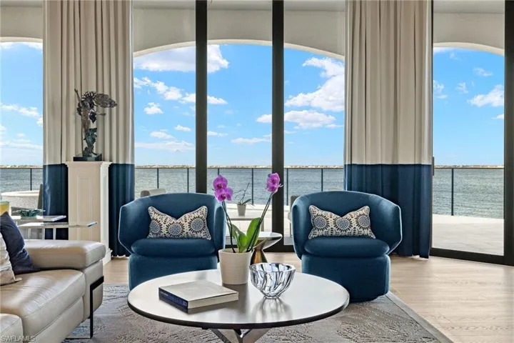 Living room with plenty of natural light, a water view, and wood-type flooring