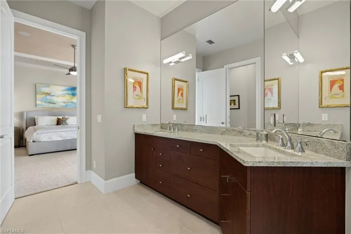 Bathroom featuring tile patterned flooring, vanity, and ceiling fan