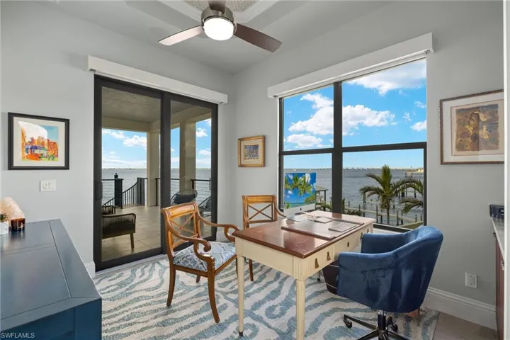 Office with hardwood / wood-style flooring and ceiling fan