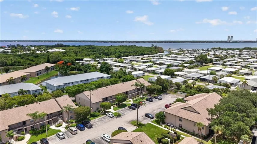 Aerial perspective showcasing the surrounding community with water frontage