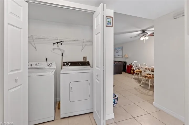 Dedicated laundry closet featuring a built-in washer and dryer