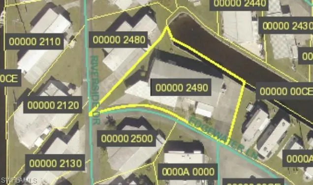 Aerial overview of property's location near canal with property parcel outlined