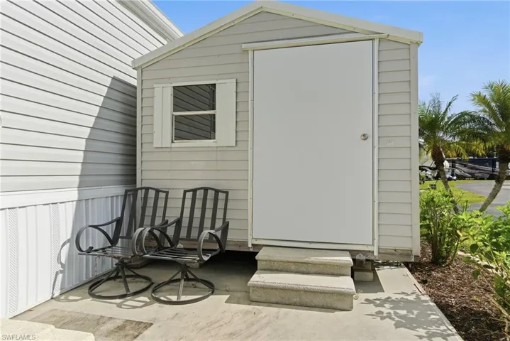 View of outbuilding with entry steps