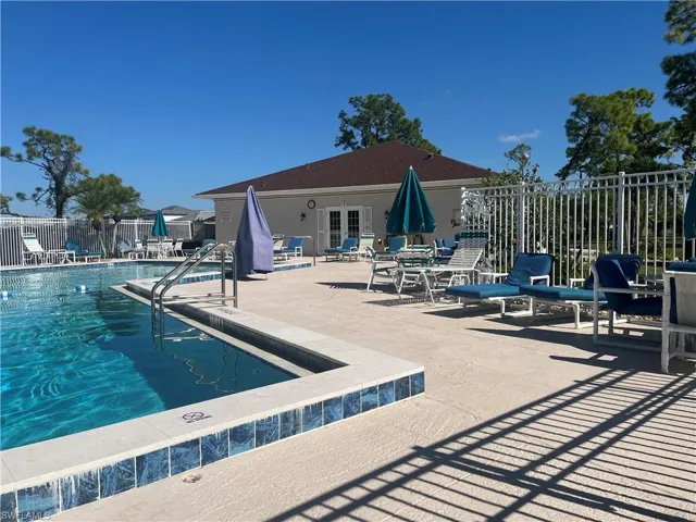 Community pool with a patio area and french doors