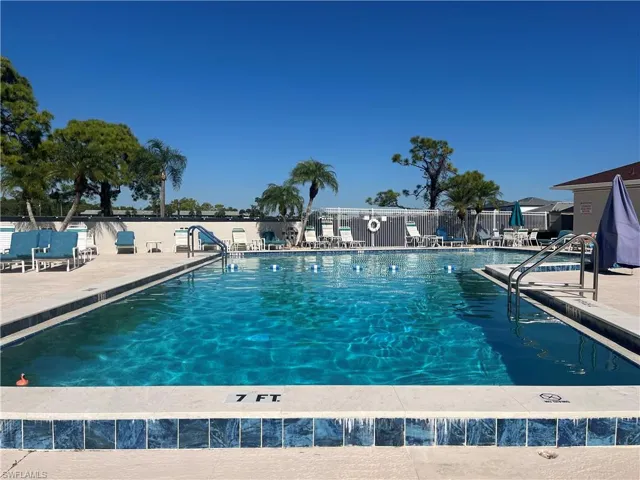 Community pool with a patio