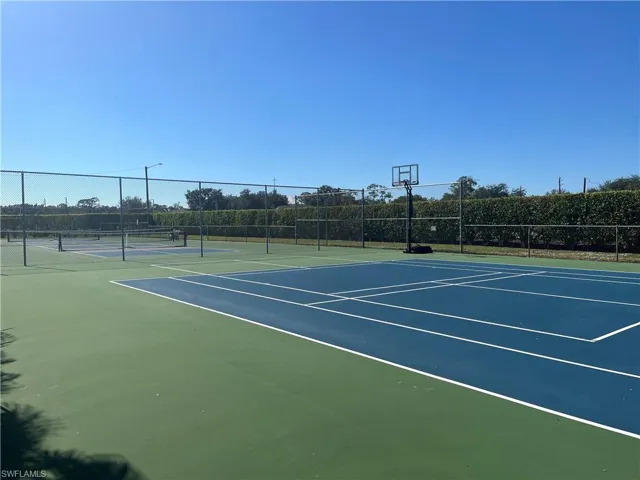 View of tennis court featuring community basketball court