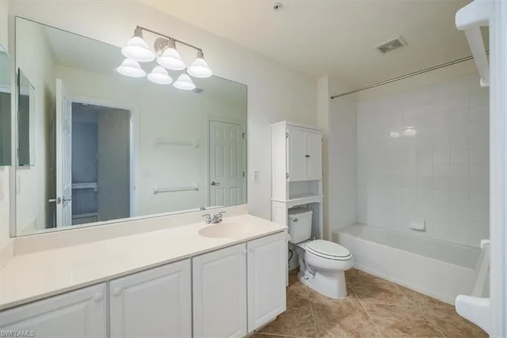 Bathroom featuring vanity,  shower combination, and tile floors