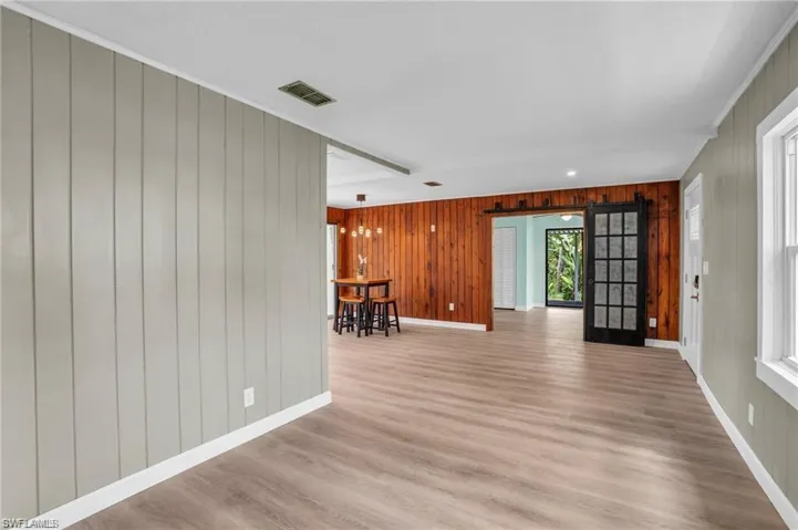 Empty room featuring baseboards, visible vents, and light wood-style floors