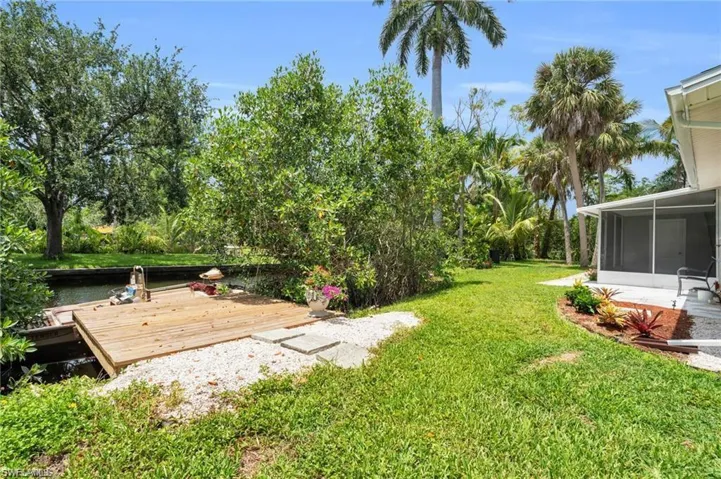 View of yard with a sunroom and a deck