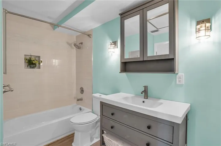 Bathroom with toilet, vanity, and bathing tub / shower combination