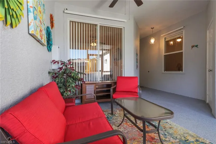 Screened in patio with access to primary bedroom; door to the right accesses the garage