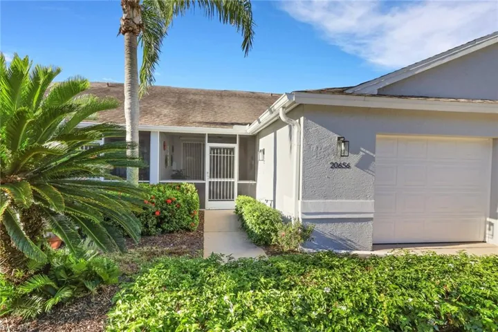 Attached villa with one-car garage and screened-in lanai area