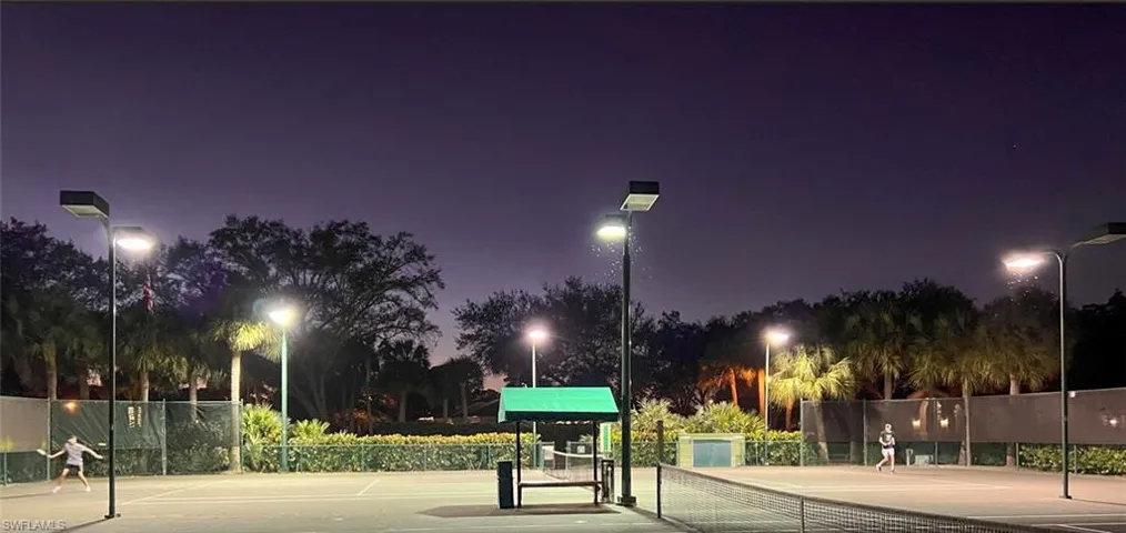 Two tennis courts with lights