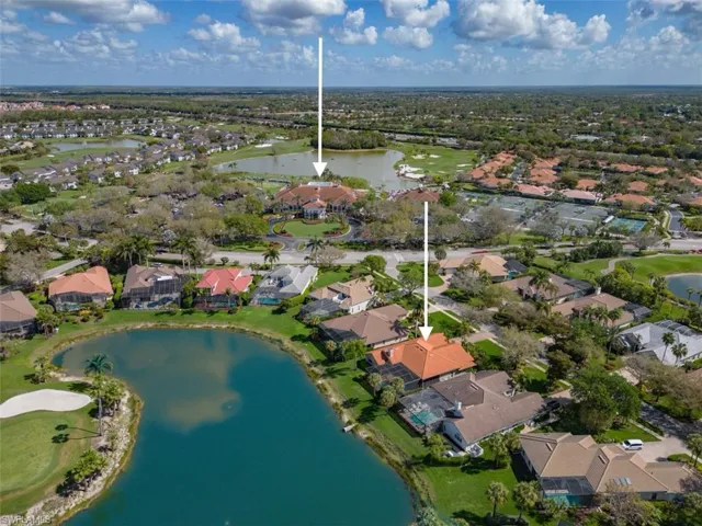 Aerial view of residential area with a large body of water and a local golf course