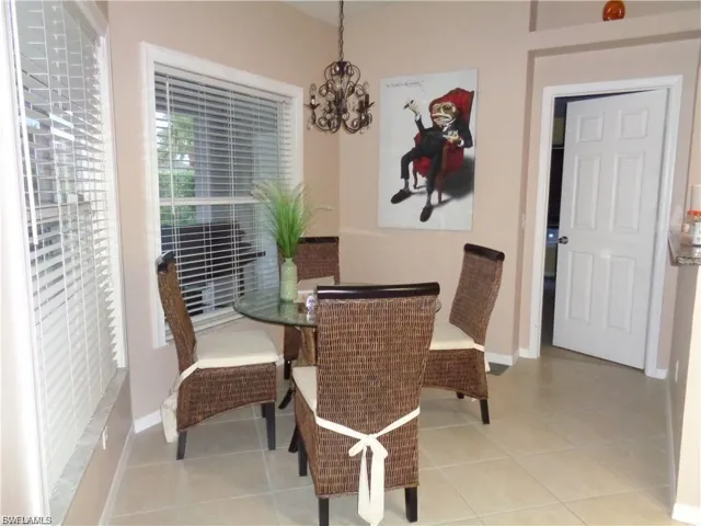 Dining area featuring hanging lights and light tile patterned floors