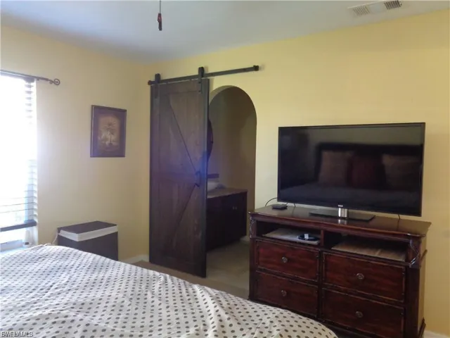 Bedroom featuring a barn door