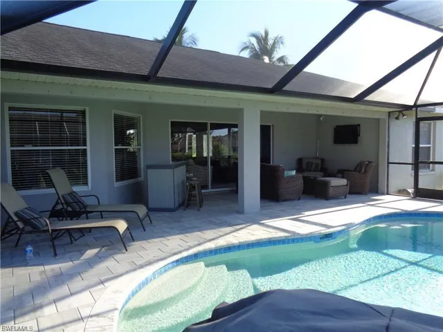 Swimming pool with a sunroom, an outdoor lounge area, a lanai, and a patio area