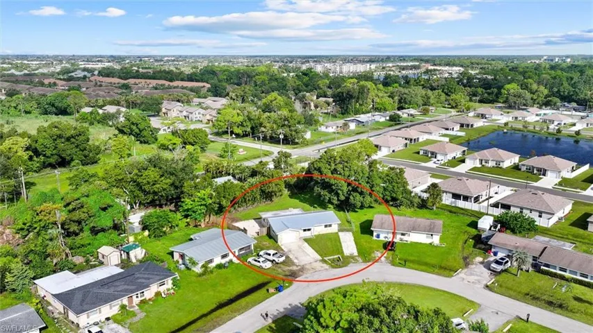 Expansive lot featuring mature trees, a circular driveway, and a detached structure
