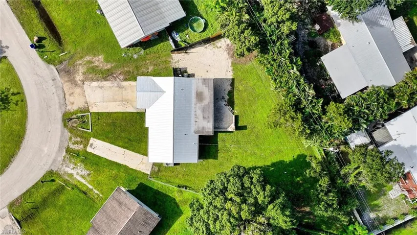 Single-story residence with a light gray roof, set on a grassy lot