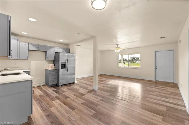 Open concept living area featuring wood-finish flooring and a ceiling fan