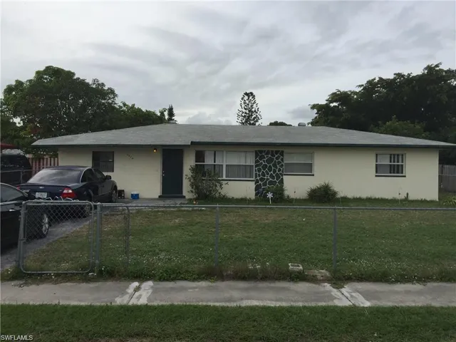 Single story home featuring a front lawn