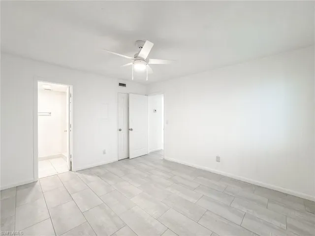 Unfurnished bedroom with baseboards and a ceiling fan