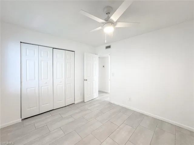 Unfurnished bedroom featuring ceiling fan and a closet