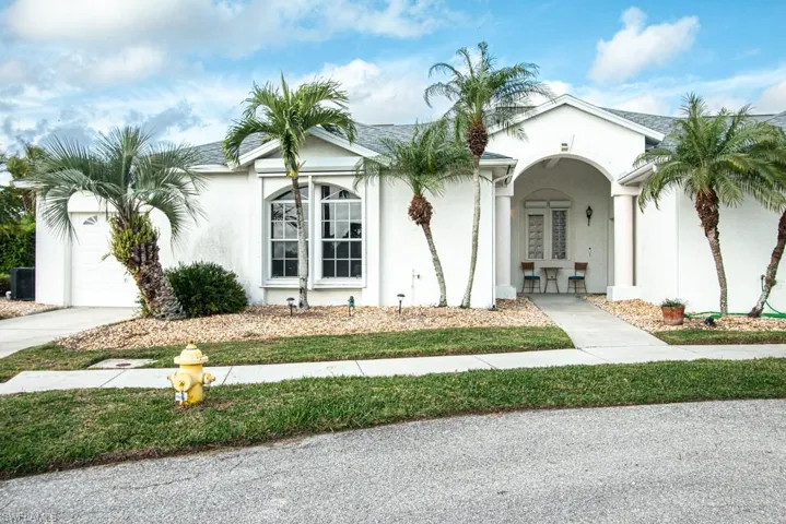 Mediterranean / spanish house with stucco siding, a shingled roof, and a garage