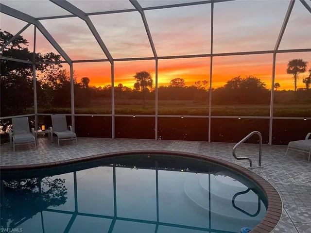Swimming pool with a sunroom and a lanai