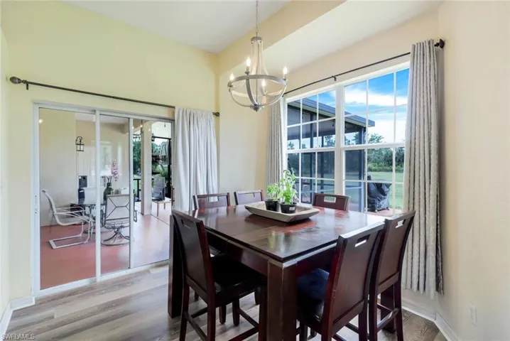 Dining space featuring an inviting chandelier and wood-type flooring