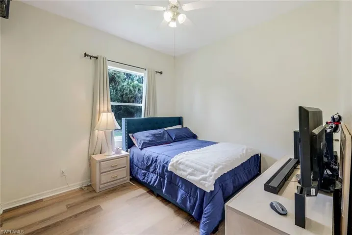 Bedroom with ceiling fan and light hardwood / wood-style flooring