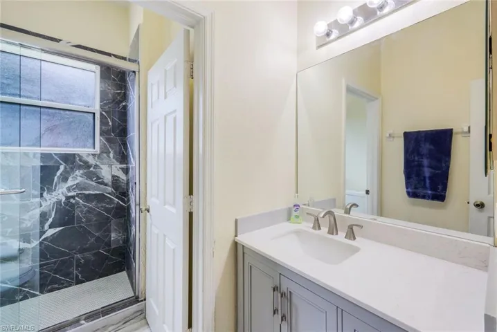 Bathroom with walk in shower and vanity