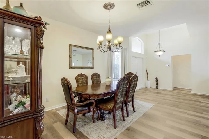 Dining area featuring light hardwood / wood-style floors and an inviting chandelier