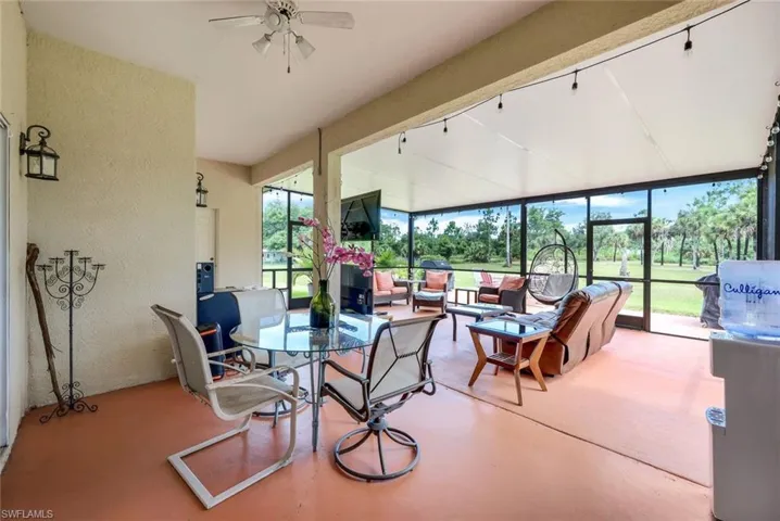 Sunroom with track lighting and ceiling fan