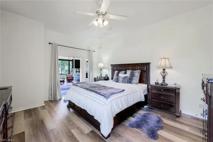 Bedroom with ceiling fan and hardwood / wood-style flooring