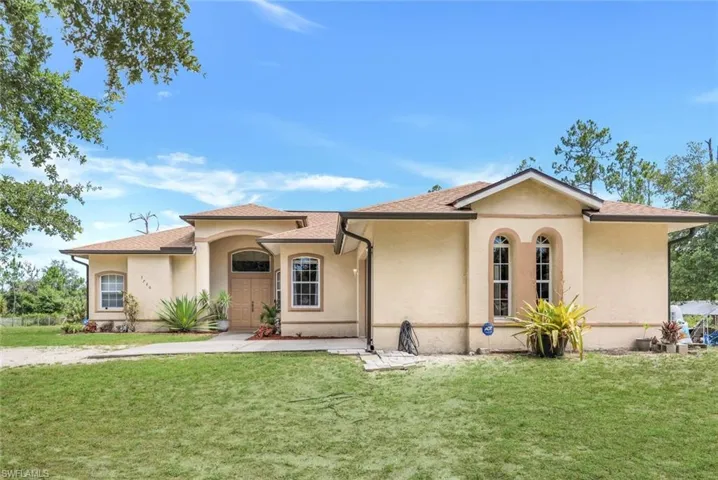 Mediterranean / spanish-style home with a front yard