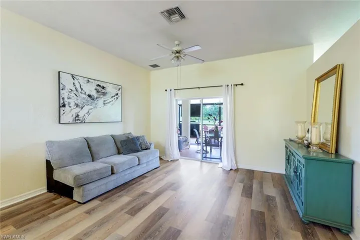 Living room featuring wood-type flooring and ceiling fan