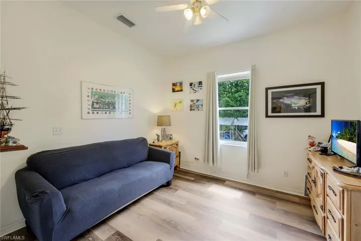 Living room featuring light hardwood / wood-style floors and ceiling fan