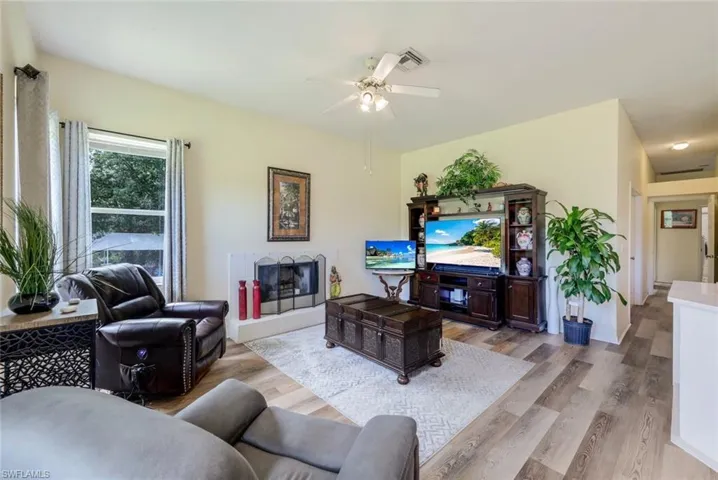 Living room featuring hardwood / wood-style floors and ceiling fan