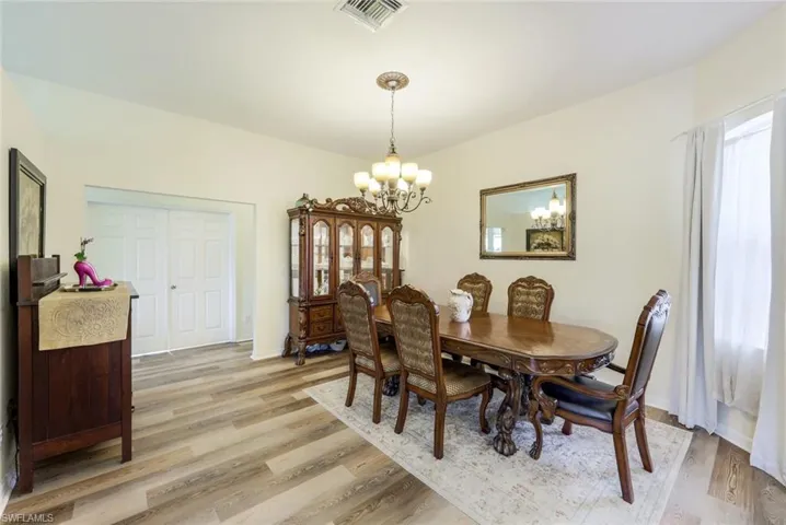 Dining room featuring light hardwood / wood-style flooring and a chandelier