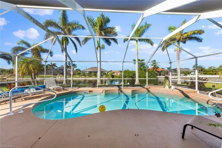 View of pool with a lanai, a water view, and a patio
