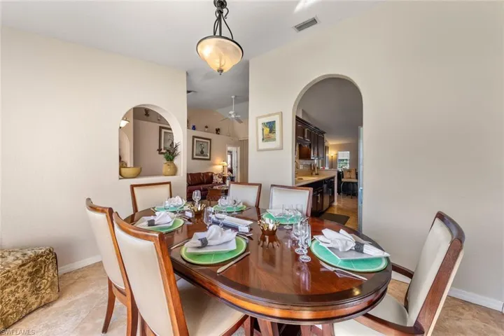 Tiled dining room featuring ceiling fan and lofted ceiling