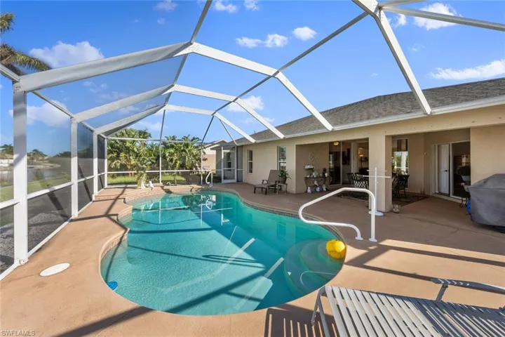 View of swimming pool featuring a lanai and a patio