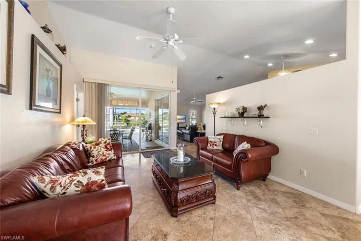 Living room with ceiling fan and vaulted ceiling