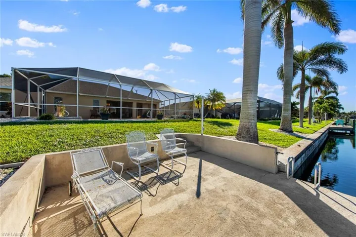 View of patio with a lanai and a water view