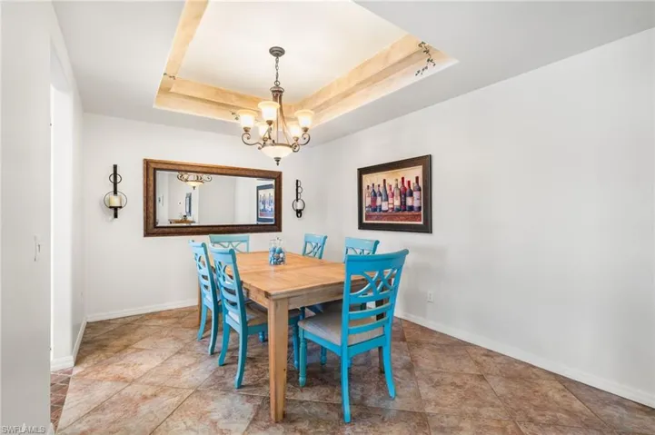 Formal dining area has double tray ceilings.