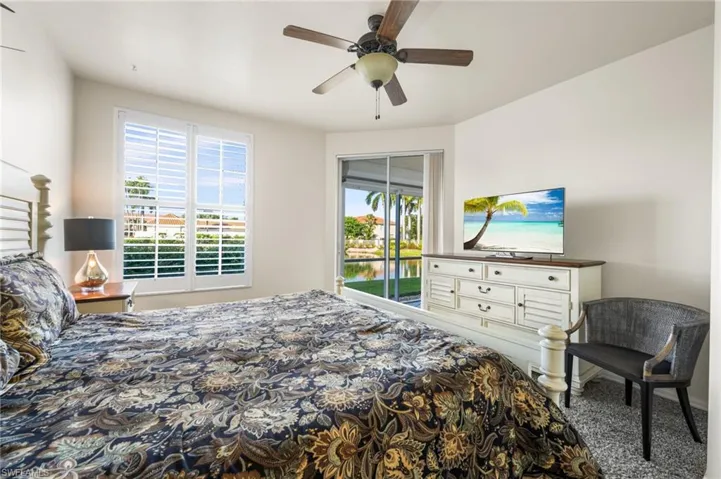Bedroom featuring carpet, access to outside, ceiling fan, and a closet