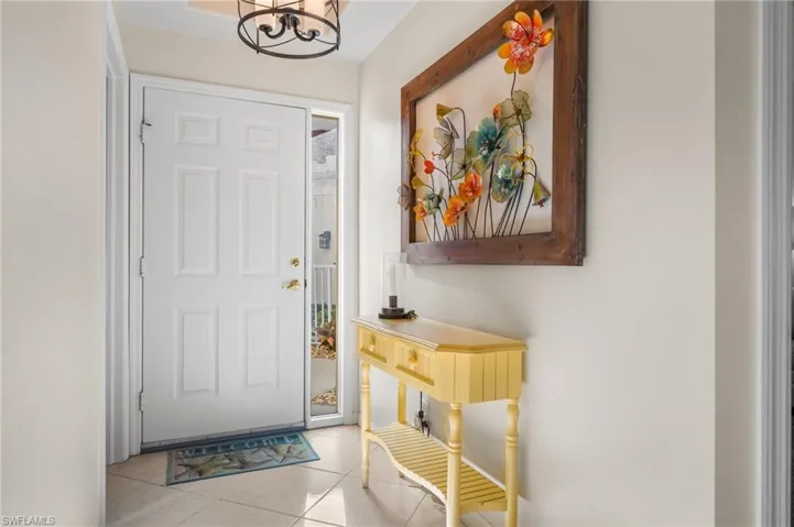 Tiled entrance foyer featuring a chandelier.
