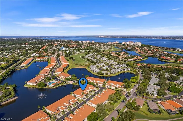 Birds eye view of property with a water view